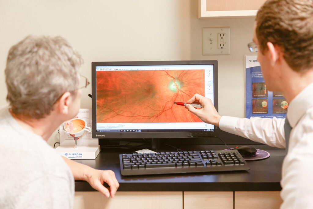Doctor Ward shows a patient her retinal images on a computer