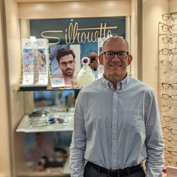 Jeff the pre tester standing in front of a glasses display